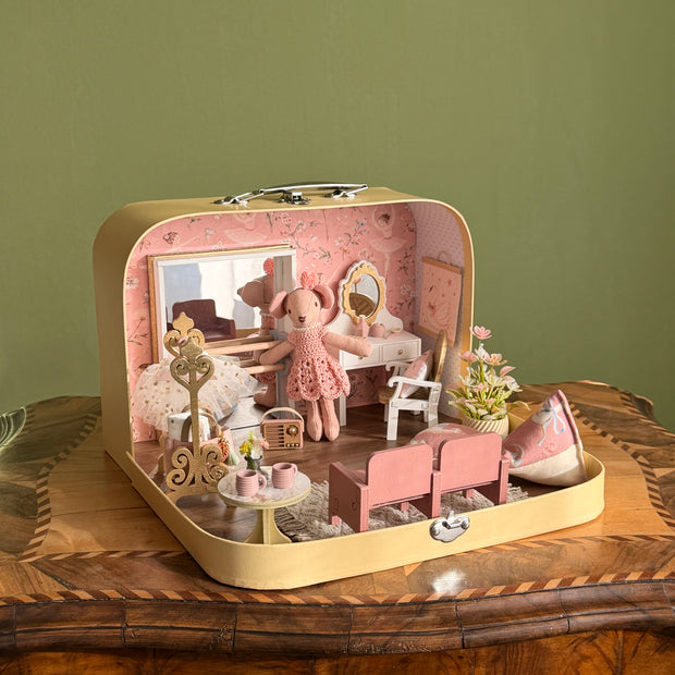 Tiny Ballerina medium suitcase dollhouse open on a wooden table, with ballet studio, vanity table and pink theatre seats