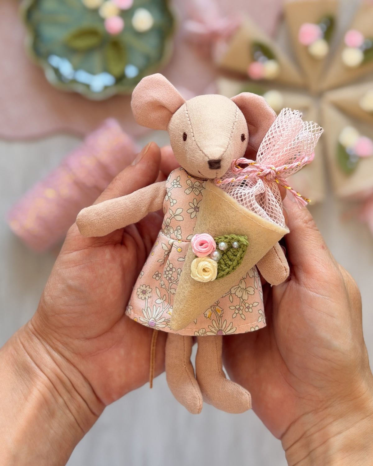 Handmade mouse doll in a floral dress holding a tiny felt school cone (Schultüte) with flowers